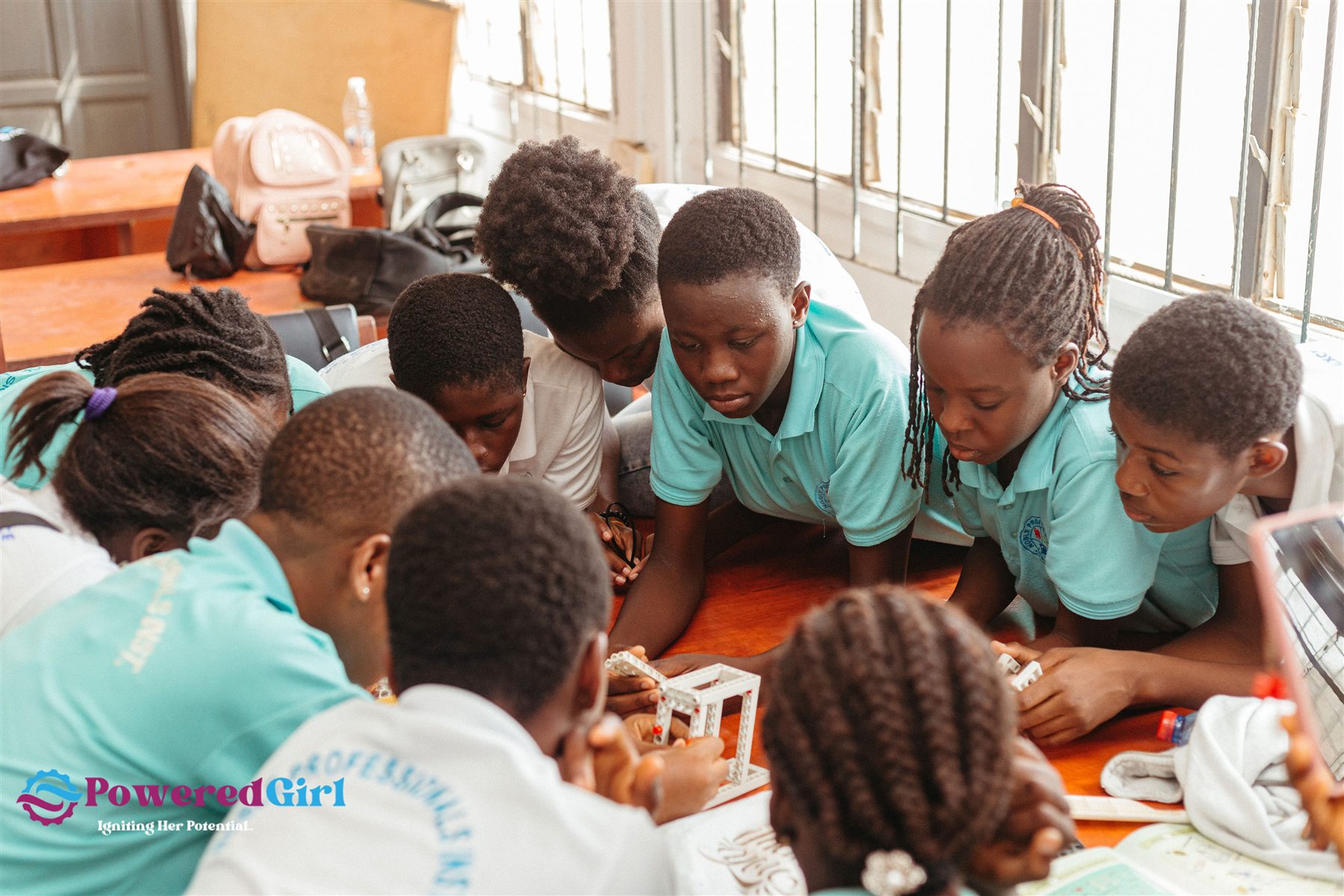 Powered Girl participants working together on a practical challenge